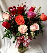 Dozen mixed roses arranged in a vase with (VD) Filler, heart pic and bow! COLOR OF ROSES WILL VARY DEPENDING ON STOCK)