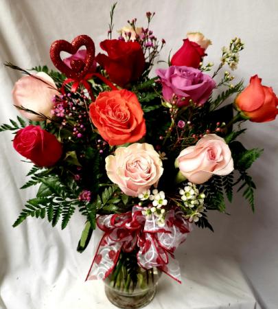 Dozen mixed roses arranged in a vase with (VD) Filler, heart pic and bow! COLOR OF ROSES WILL VARY DEPENDING ON STOCK)