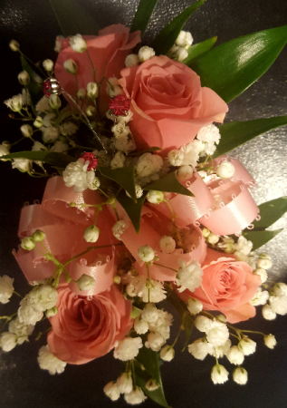Wrist corsage with 4 spray roses and filler. Visit corsage link