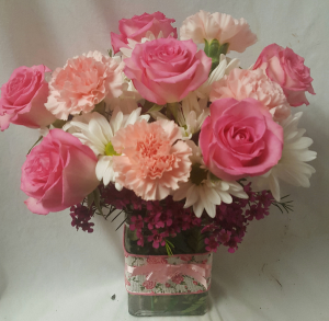 "PINK DELIGHT"...PINK ROSES, PINK CARNATIONS, and white daisies with filler arranged in a cute ribbon detailed rectangular vase! 