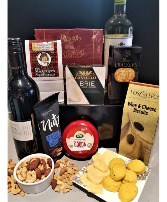 AN ESSENTIAL GOURMET HAMPER. Red and white wine with salty and sweet treats