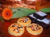 Image of Gerbera daisy attached to a box of 3 famous <br/>brownies, 3 iced sugar cookies. Order by 5:00p.m. for next day delivery. 