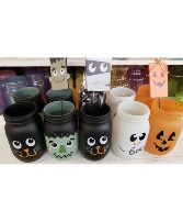 Halloween mason jars with cute pics Seasonal bright flowers arranged in jar