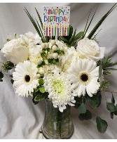 HAPPY BIRTHDAY DELIGHTFULLY WHITE! All whites flowers arranged in a vase with a Happy Birthday pick! Flowers will be all white but may vary with the kinds of flowers depending on stock. 