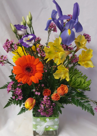 HAPPY DAYS BOUQUET..cute fabric on rectangular Vase filled with bright seasonal flowers.