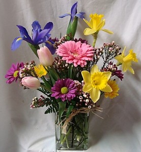 HAPPY EASTER!! Mixture of spring flowers...tulips , iris, daisies and gerbera daisy ,etc.. whatever is available.arranged in a rectangular vase.