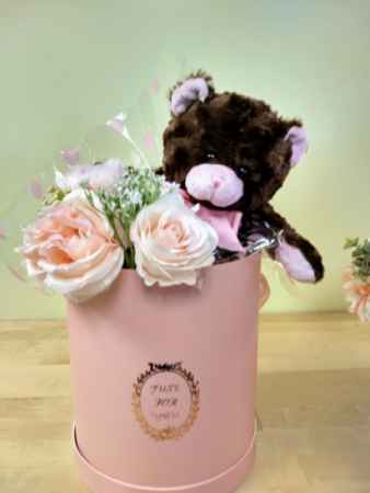 hat box with brown and pink teddy bear