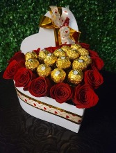 Heart box filled with roses and chocolates  