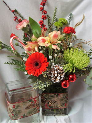 HOLIDAY CHEER! CHRISTMAS RIBBON DETAIL ON  RECTANGULAR VASE FILLED WITH RED, WHITE AND GREEN FLOWERS!!( Holiday ribbon may vary)