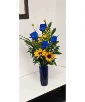 Janet Mixed flowers in a blue glass vase 