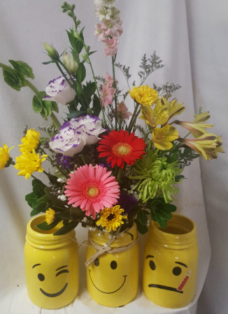 NEW!!Cute bright yellow mason jars with smiley, and get well FACES. We will select the smiley or wink face if card is not about someone sick. If card is saying Get Well we will select that one. Flowers will be bright and cheery. May look different according to stock.