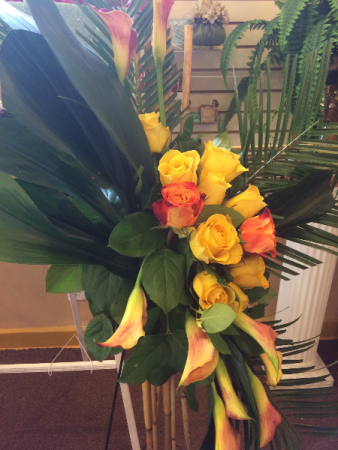 Lady J'S Bamboo Spray Yellow calla lillies/variegated roses with bamboo sticks on stand
