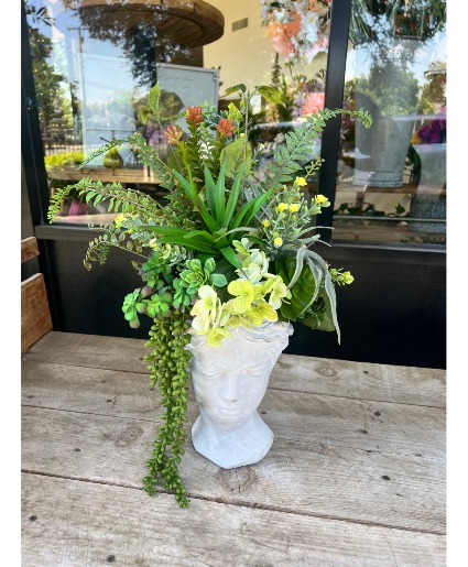 Lady planter with artificial succulents Artificial succulents in a garden