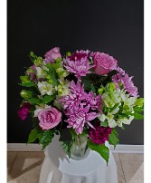 lavender and white flower arrangement in a vase 