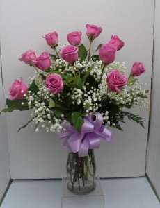 Lavender long stemmed roses Arranged in glass vase