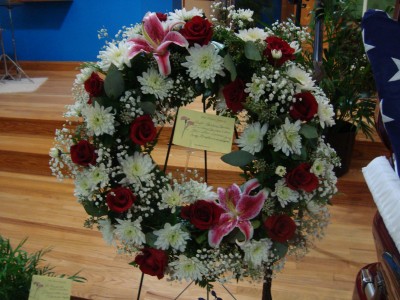 Round wreath with Red and White flowers For a standing Spray