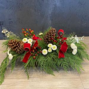 Long and low arrangement winter greenery centerpiece