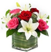 Lovely Lily and Rose Romance Includes red and pink roses, white lilies and a square glass vase
