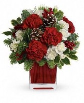 "CHRISTMAS DELIGHT"Red and white flowers with pinecones and holiday greens in a CLEAR  vase. 