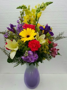 Make Me Smile Bouquet Brightly Colored Spring Arrangement in a Purple Vase