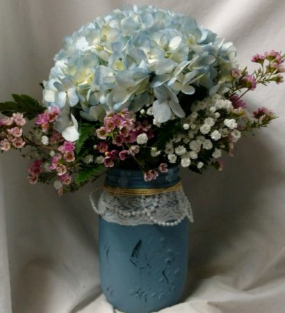 One pretty blue hydrangea in a mason jar with Wax flower!