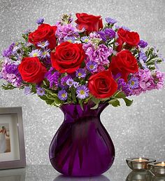 PURPLEFLOWERS Red Roses with purple flowers all arranged in a CLEAR VASE!