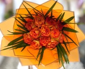 Orange roses wrapped in orange paper 