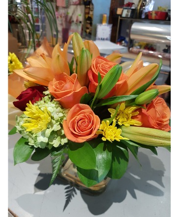 ORANGE CRUSH  Arrangement in a glass cube. in Halifax, NS | Twisted Willow