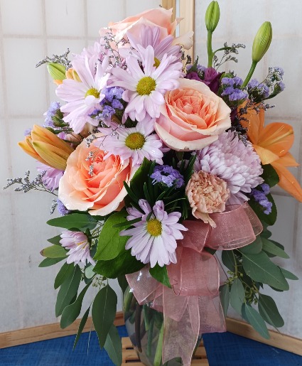 Peachy Keen Beautiful Peach Roses and Lavender Blooms in a clear vase