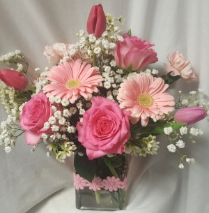 "SHADES OF PINKS"Seasonal pink flowers in a DAISY  ribbon detailed rectangular  vase.