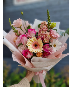 Pink wrapped bouquet Assorted flowers with pinks 