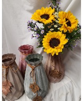 3 SUNFLOWERS  IN TALL  CERAMIC VASE WITH DANGLING LEAF WITH SEASONAL FILLER...VASE Comes in different colors POPULAR LIMITED SUPPLY