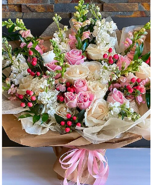 Premium Pink wrapped bouquet  Assortment of seasonal florals with pink