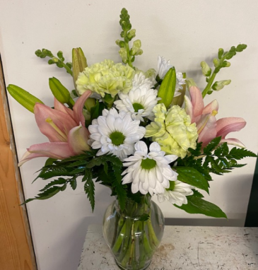 Pretty in pink Fresh arrangement with daisies, lilies, and carnations!