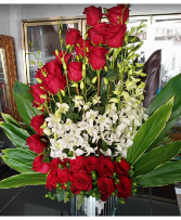 Pure Elegance $550 Lovely Red Roses and Orchid Arrangement