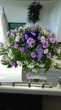 Purple carnations with baby's breath and greenery Sympathy