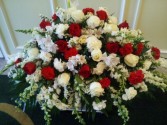 RED AND WHITE TRIBUTE Half Couch of red and white roses, white snapdragons, carnations , larkspur and more.