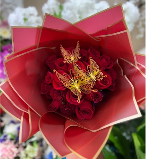 Red roses with butterflies wrapped in red paper  