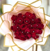 Red roses wrapped in pink paper