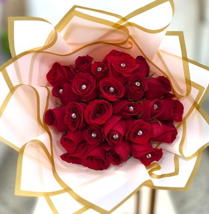 Red roses wrapped in pink paper
