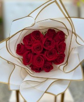 Red roses wrapped in white paper