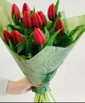 Red Tulips Wrapped with Christmas greenery  