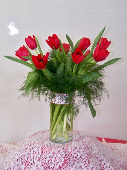 Romantic Red Tulips Ten tulip stems arranged in a vase with greens and fillers.