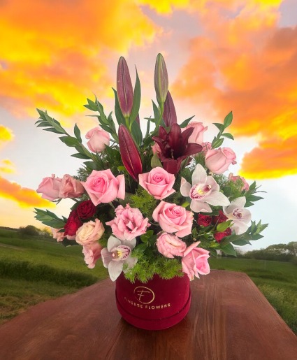 Rose  and other flowers in a red velvet box Flower arrangement 