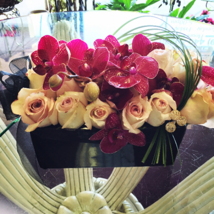 Roses and orchids in compact floral bouquet 