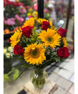 Roses and Sunflowers in a glass vase  tall arrangement 