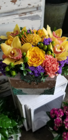 rustic box filled with orchids etc