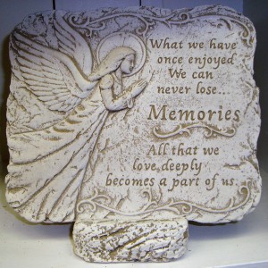 A memorial garden stone displayed on a stone  easel. Nice keepsake that could be placed in a garden to remember a loved one. Comes with a bow. 