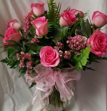DOZEN PINK ROSES ARRANGED WITH WAX FLOWER OR BABY' BREATH...WHAT EVER IS IN STOCK AND SEASONAL