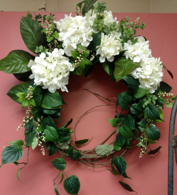 Silk, outdoor or indoor wreath White hydrangea and garden foliage.